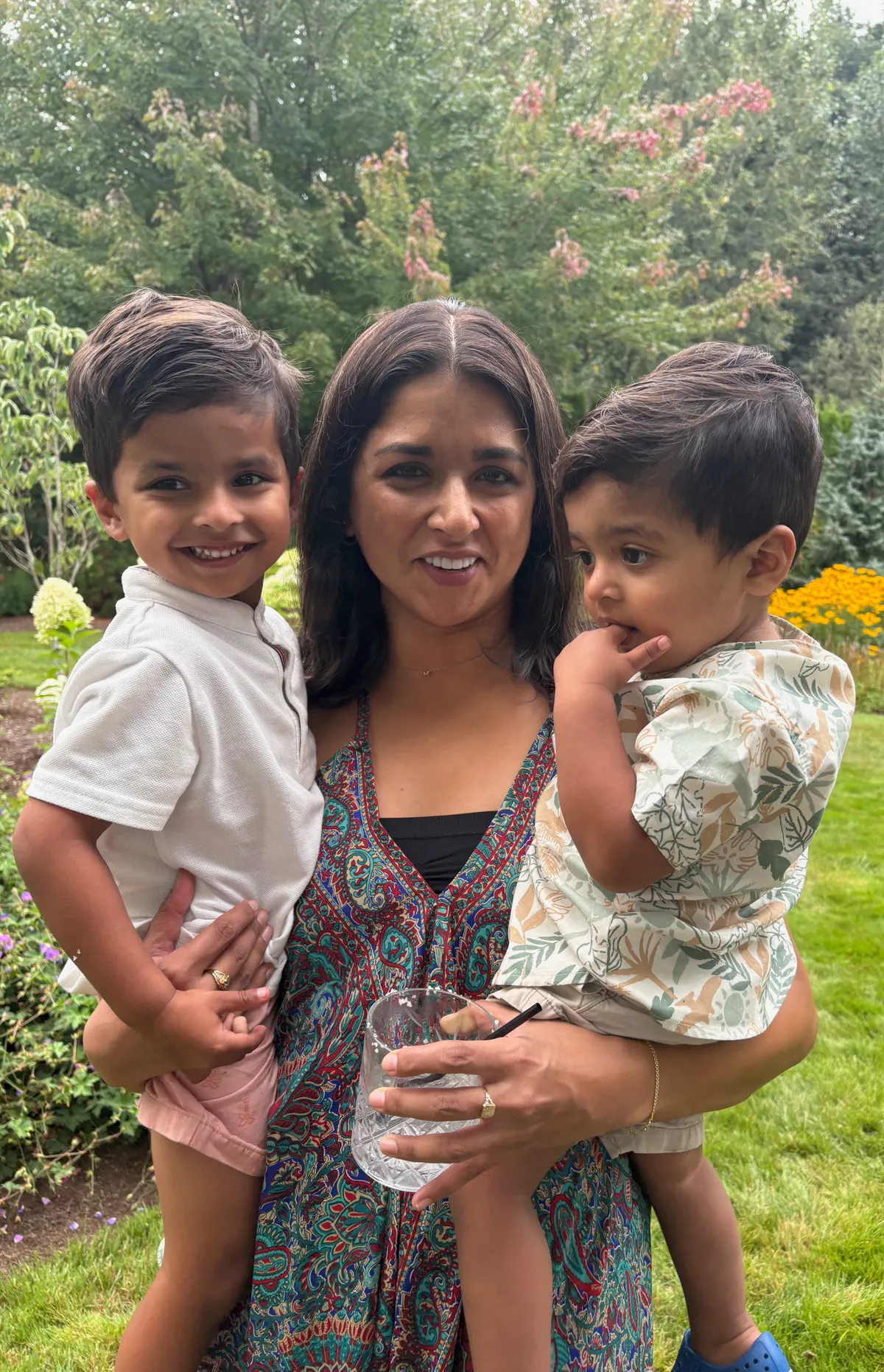 Dr. Shabita Teja outdoors with her two sons, smiling
